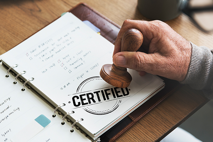 Man holding a chop to certified a page